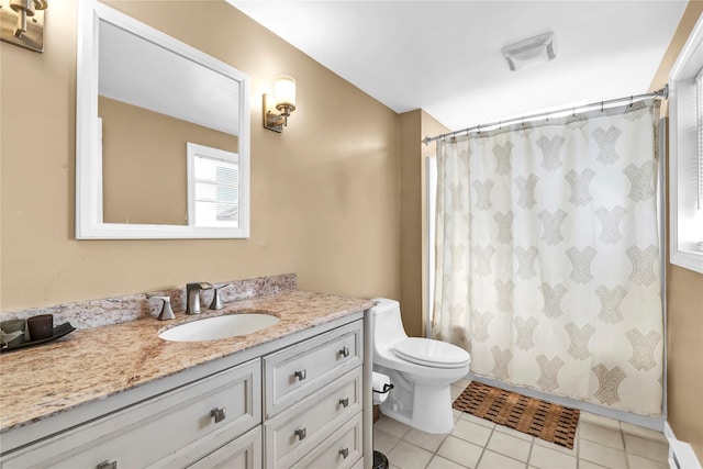 bathroom featuring vanity, tile patterned floors, and toilet