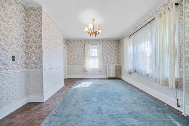 unfurnished room with radiator and a notable chandelier