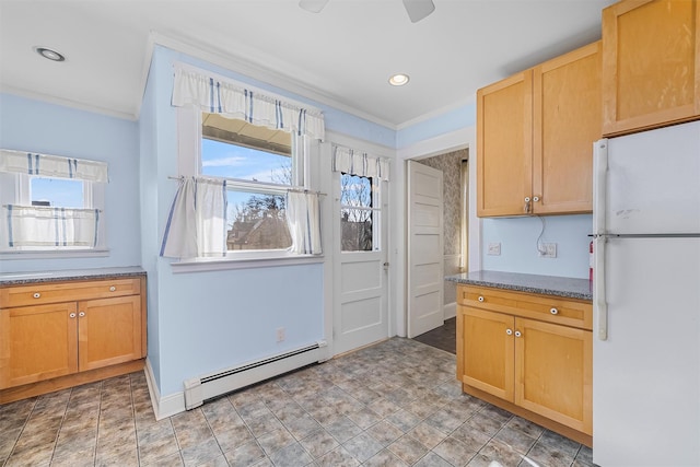 kitchen featuring ornamental molding, baseboard heating, and white refrigerator