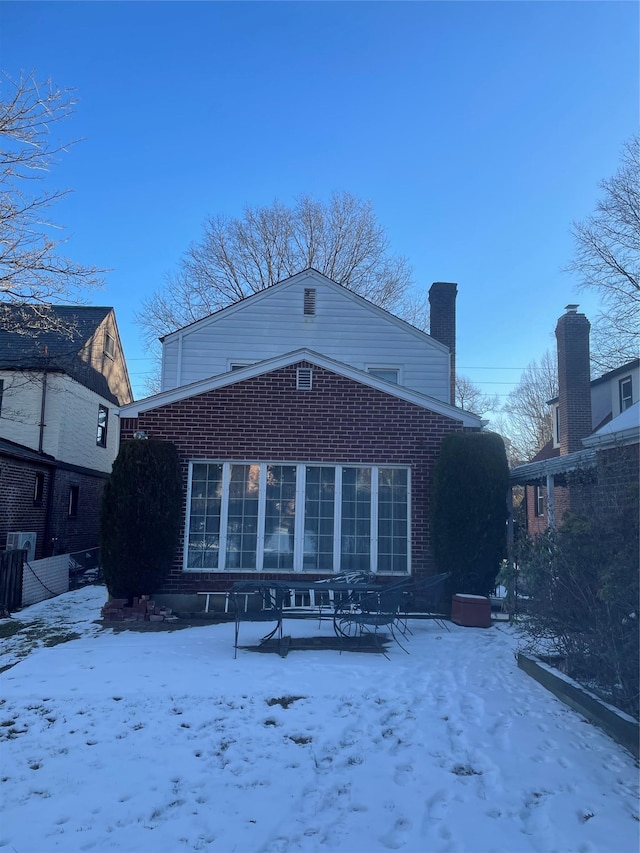 view of snow covered rear of property