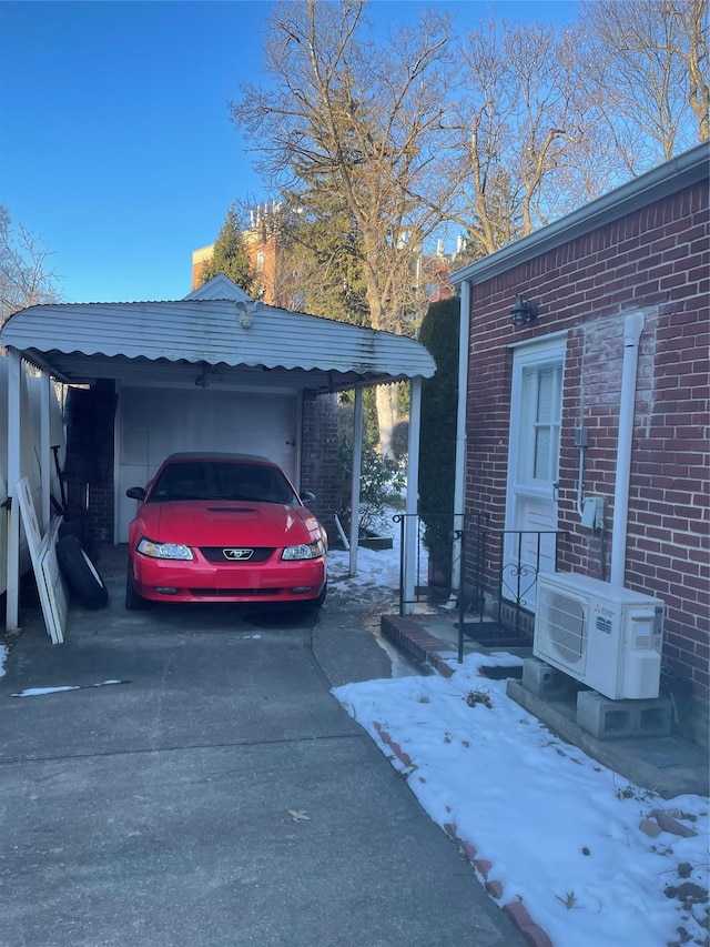 snow covered property with ac unit and a carport