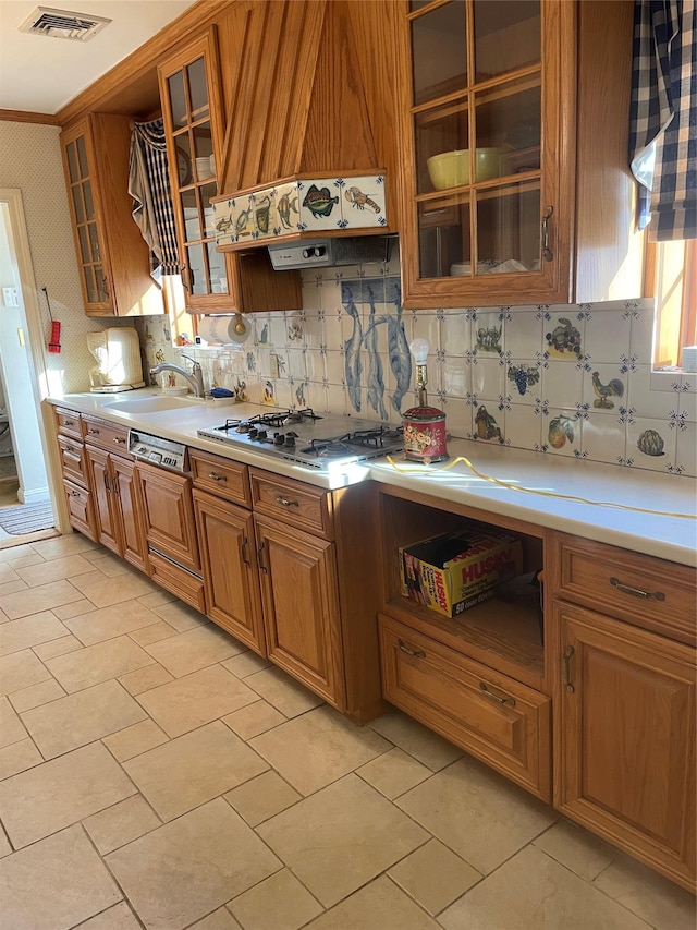 kitchen featuring tasteful backsplash, stainless steel gas stovetop, and sink