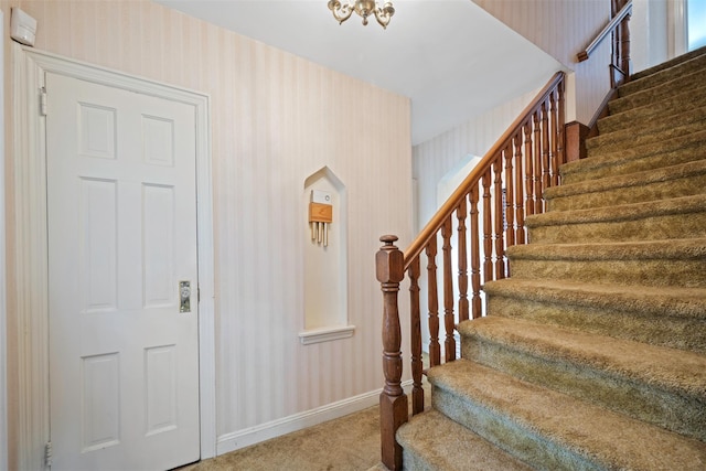 47-44 Glenwood St, Little Neck, NY 11362 - carpeted foyer with wallpapered walls, stairs, baseboards, and arched walkways