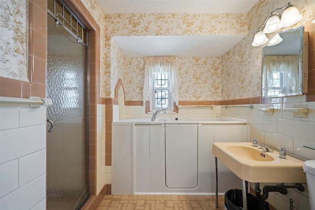 47-44 Glenwood St, Little Neck, NY 11362 - full bathroom featuring tile walls, wallpapered walls, wainscoting, a shower stall, and a sink