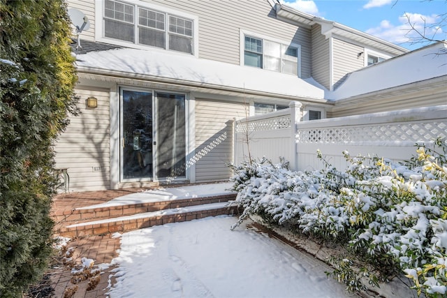 view of snow covered rear of property