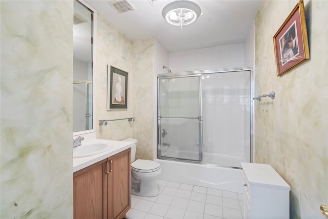 full bathroom featuring enclosed tub / shower combo, vanity, toilet, and tile patterned floors