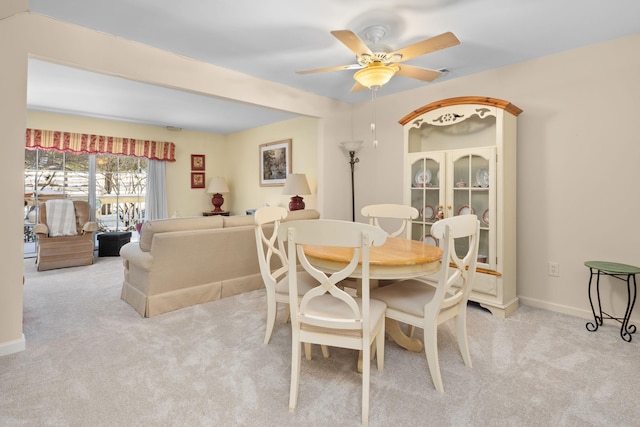 carpeted dining area featuring ceiling fan