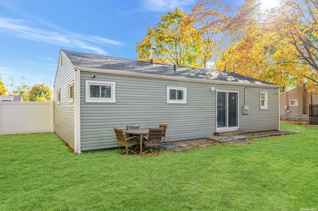 rear view of property with a lawn