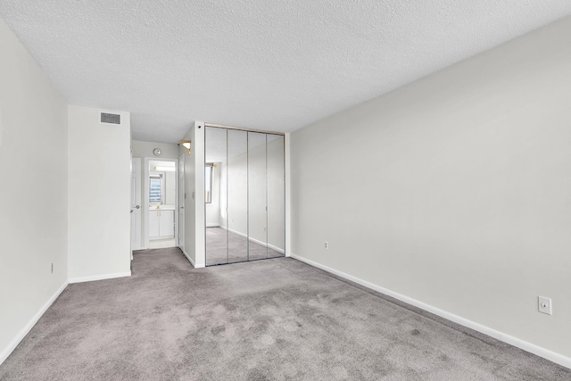 25 Rockledge Ave Unit 906W, White Plains, NY 10601 - unfurnished bedroom with visible vents, baseboards, carpet floors, a closet, and a textured ceiling