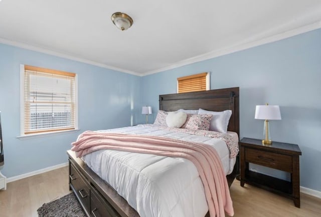 bedroom with crown molding and light wood-type flooring