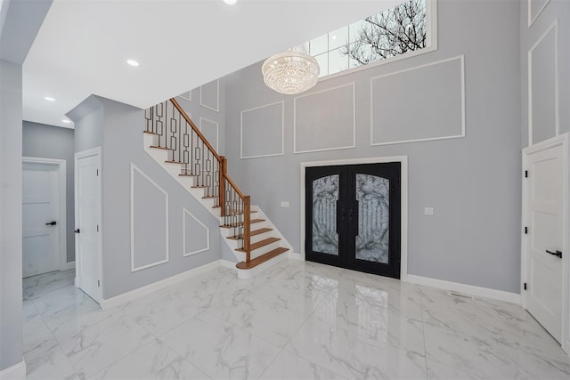 foyer with a notable chandelier and french doors