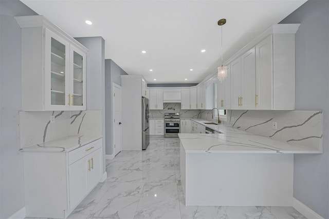 kitchen with pendant lighting, white cabinetry, sink, kitchen peninsula, and stainless steel appliances