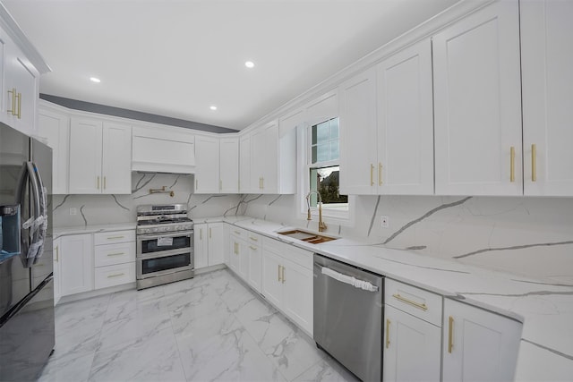 kitchen featuring white cabinetry, sink, light stone countertops, and appliances with stainless steel finishes