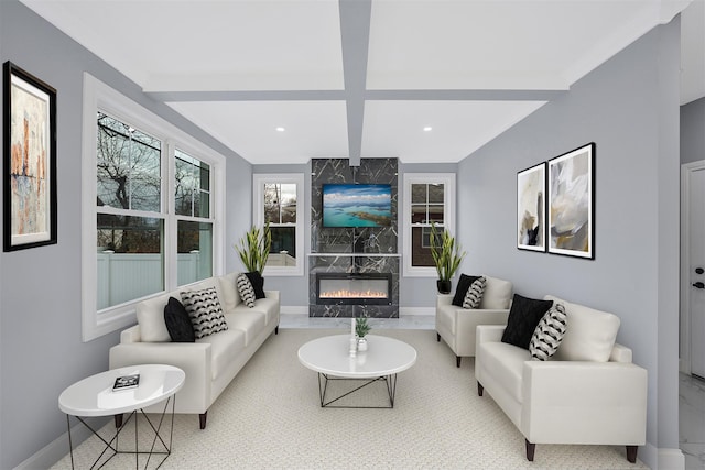 living room with beam ceiling, coffered ceiling, and a high end fireplace