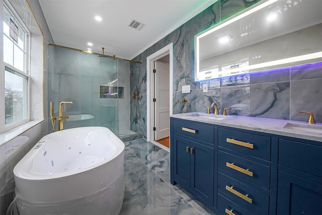 bathroom featuring vanity, shower with separate bathtub, and tile walls