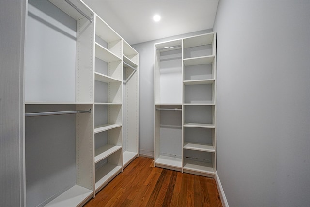 walk in closet with dark wood-type flooring