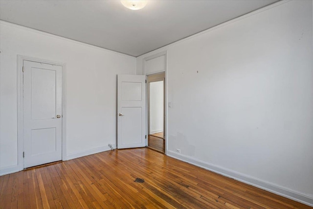 empty room with hardwood / wood-style floors