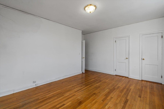 unfurnished bedroom with hardwood / wood-style floors