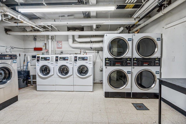 laundry area featuring stacked washer and clothes dryer and washer and clothes dryer