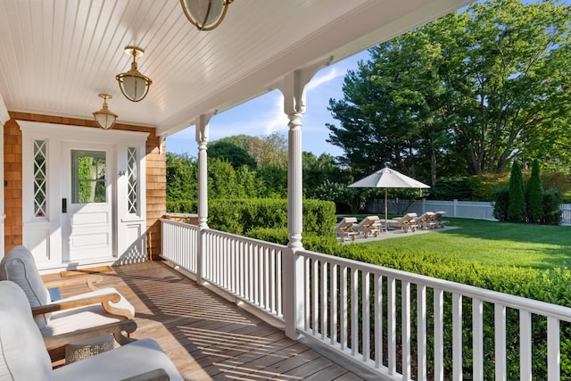 deck featuring a yard and a porch