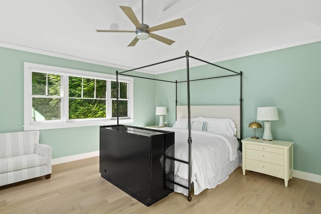 bedroom with light hardwood / wood-style flooring, ornamental molding, and ceiling fan