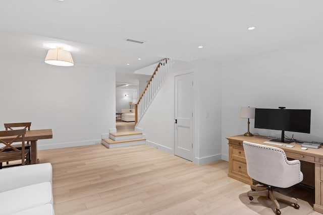 home office with light hardwood / wood-style floors