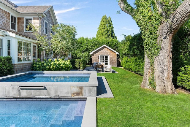 view of swimming pool with an outdoor structure and a lawn