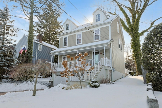 view of front facade with a porch and a garage