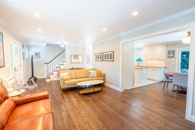 living room featuring baseboards, recessed lighting, wood finished floors, stairs, and crown molding