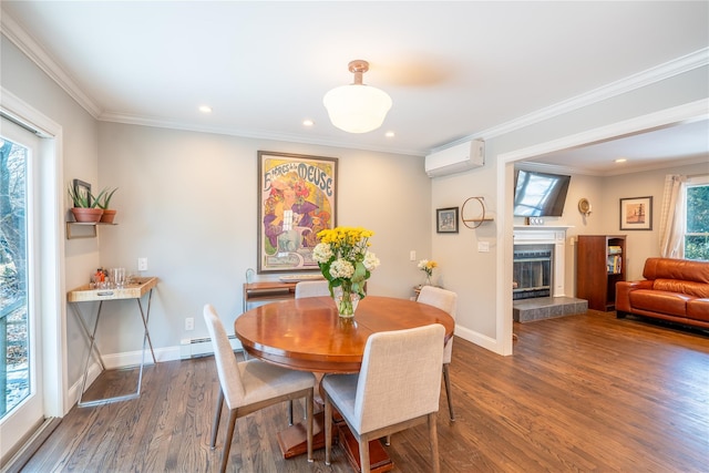dining space with a baseboard heating unit, baseboards, a glass covered fireplace, a wall mounted air conditioner, and wood finished floors