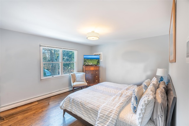 bedroom featuring a baseboard radiator and wood finished floors
