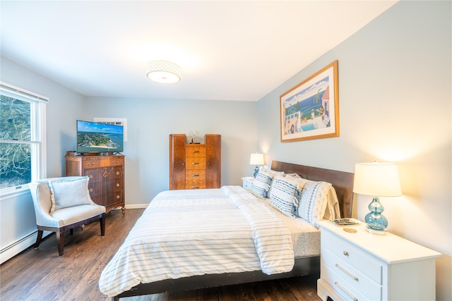 bedroom featuring dark wood-type flooring, a baseboard radiator, and baseboards