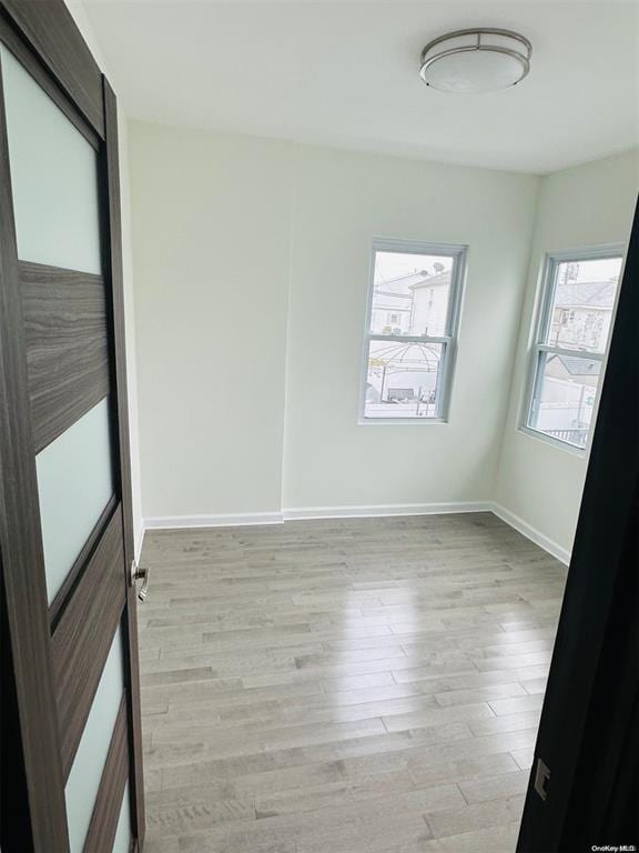 spare room featuring light hardwood / wood-style flooring