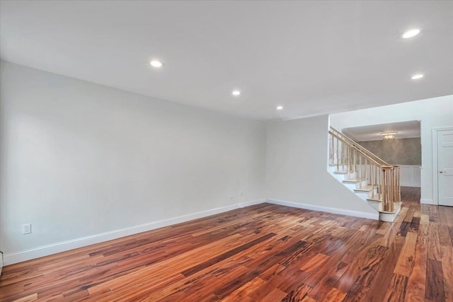 interior space featuring baseboards, recessed lighting, wood finished floors, and stairs