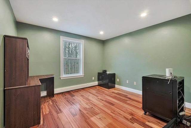 interior space featuring recessed lighting, light wood-style floors, and baseboards
