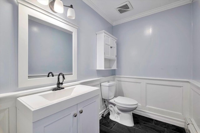 half bathroom featuring crown molding, vanity, visible vents, toilet, and a baseboard heating unit