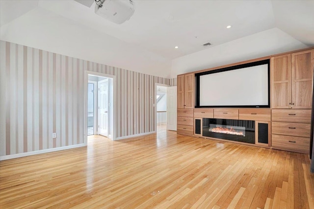 unfurnished living room featuring recessed lighting, light wood-style flooring, baseboards, and wallpapered walls