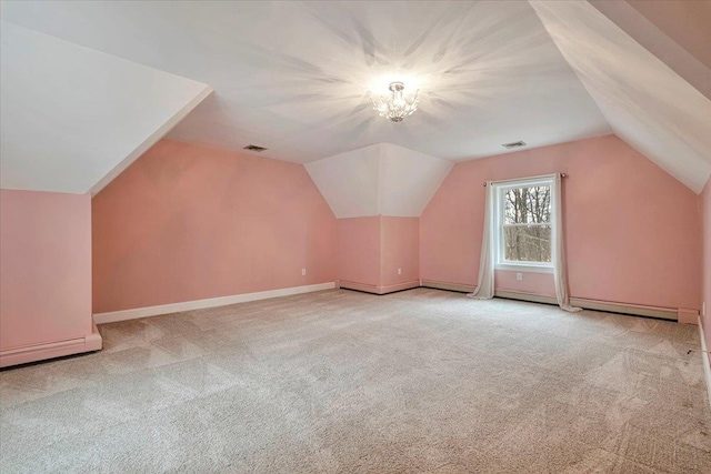 additional living space featuring visible vents, vaulted ceiling, and carpet floors