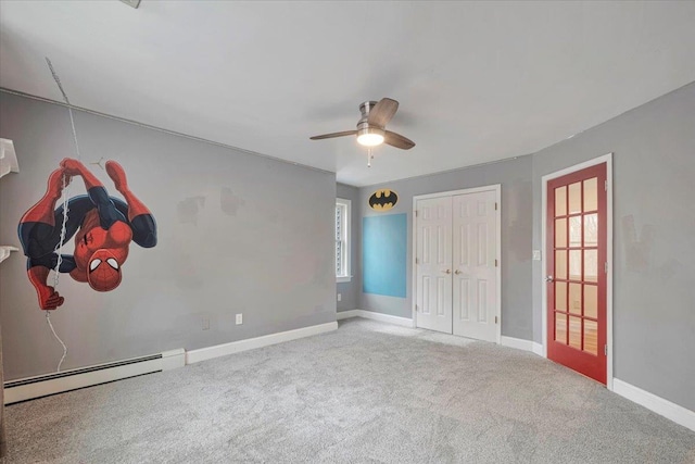 unfurnished bedroom featuring carpet floors, baseboards, multiple windows, and baseboard heating