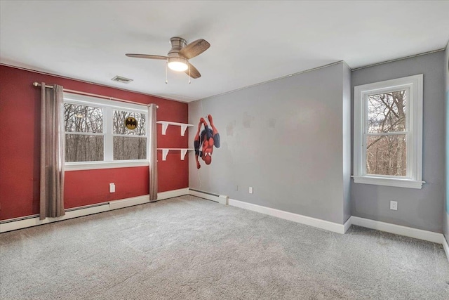carpeted spare room with ceiling fan, baseboards, and visible vents