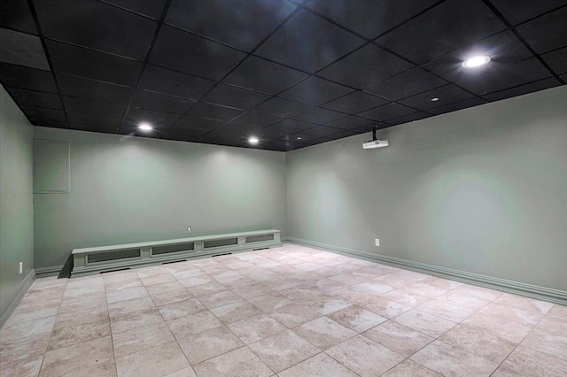 empty room featuring baseboards, recessed lighting, and a paneled ceiling