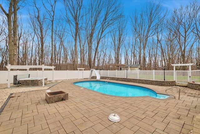 view of swimming pool with a patio, a fenced backyard, and a water slide