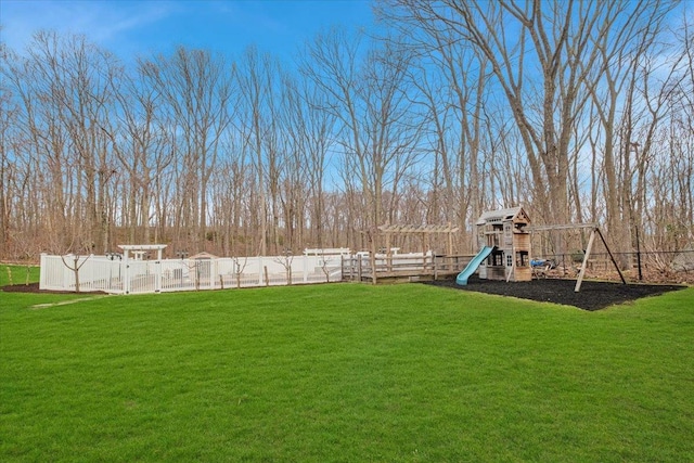 view of yard with fence and a playground