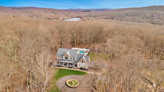 bird's eye view featuring a water view and a forest view
