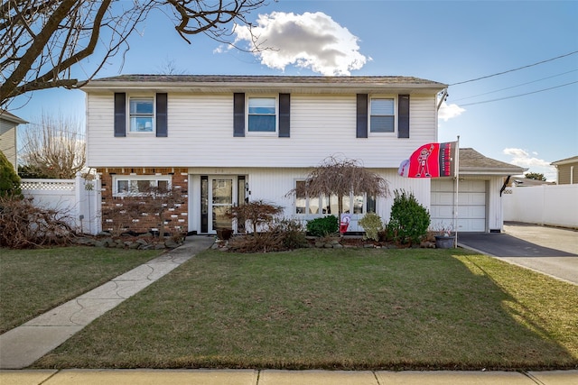 view of front of home featuring a garage and a front yard