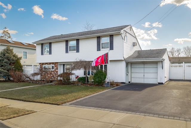 view of front of property with a garage and a front lawn