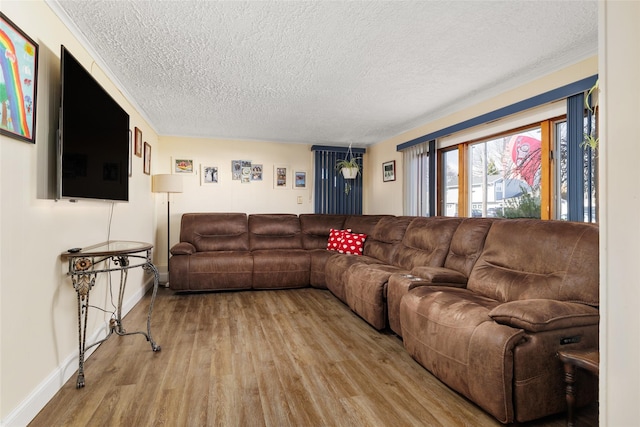 living room featuring light hardwood / wood-style floors and a textured ceiling