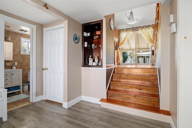 stairway featuring hardwood / wood-style floors