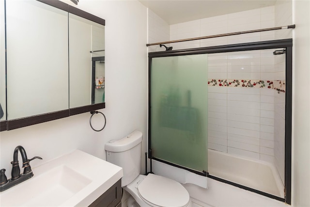 full bathroom featuring vanity, toilet, and combined bath / shower with glass door