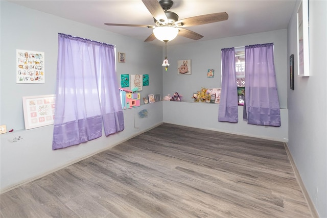 empty room with hardwood / wood-style flooring and ceiling fan